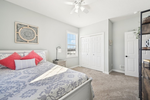 carpeted bedroom featuring ceiling fan and a closet