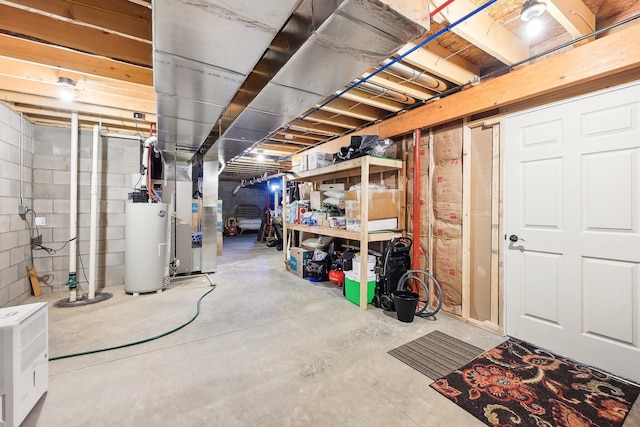 basement featuring heating unit and water heater