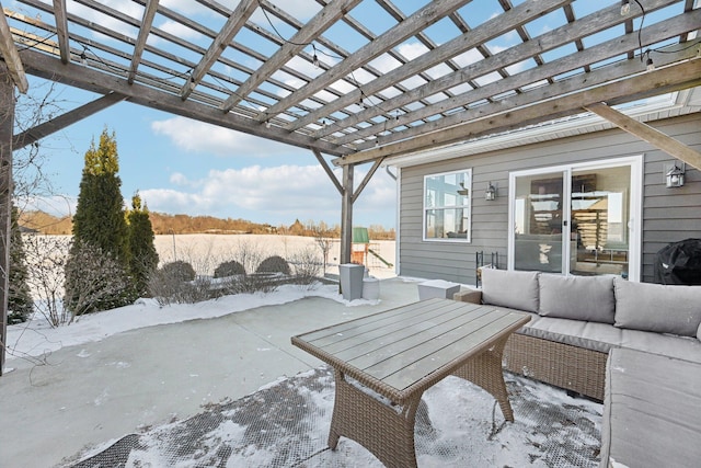 snow covered patio with outdoor lounge area and a pergola