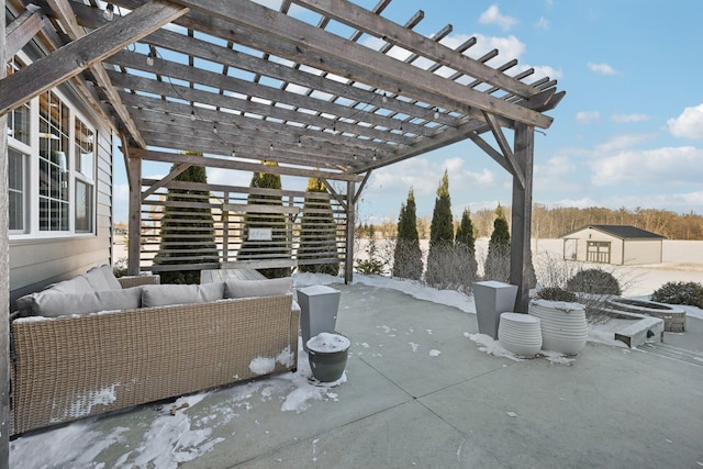 snow covered patio with an outdoor living space and a pergola