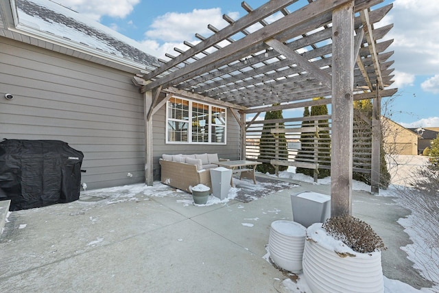 snow covered patio with an outdoor hangout area and a pergola