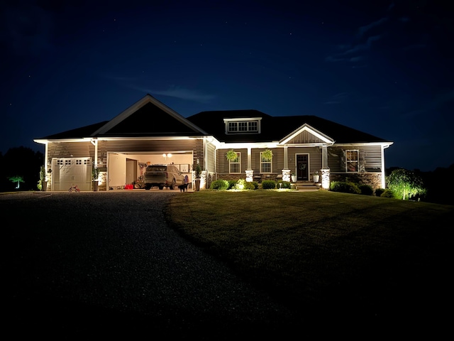 craftsman house with a garage and a lawn