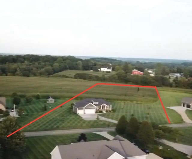 birds eye view of property with a rural view