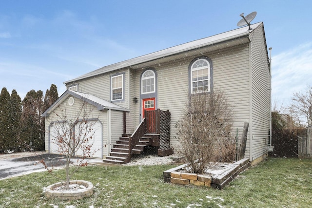 raised ranch with a front lawn and a garage