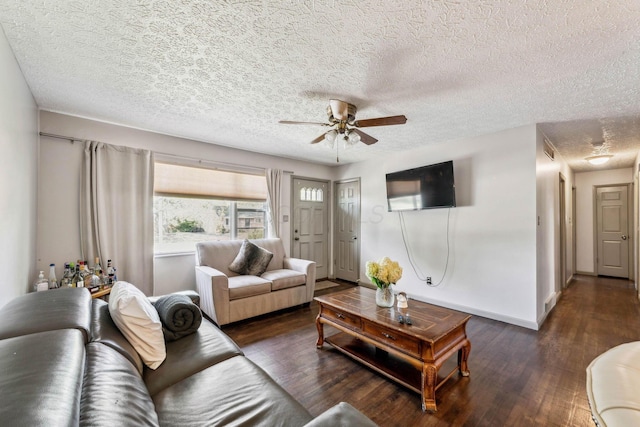 living room featuring ceiling fan, dark hardwood / wood-style flooring, and a textured ceiling