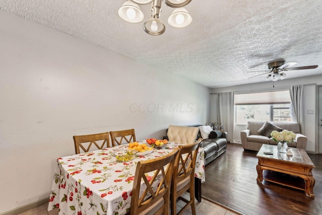 dining room featuring ceiling fan and a textured ceiling