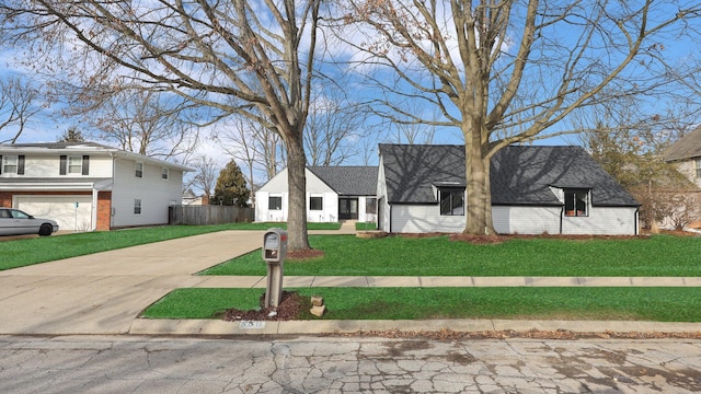 view of front of property with a front yard and a garage