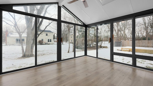 unfurnished sunroom featuring ceiling fan and vaulted ceiling