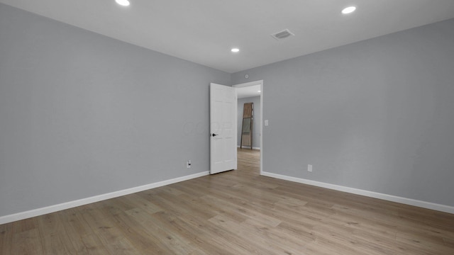 unfurnished room with light hardwood / wood-style flooring