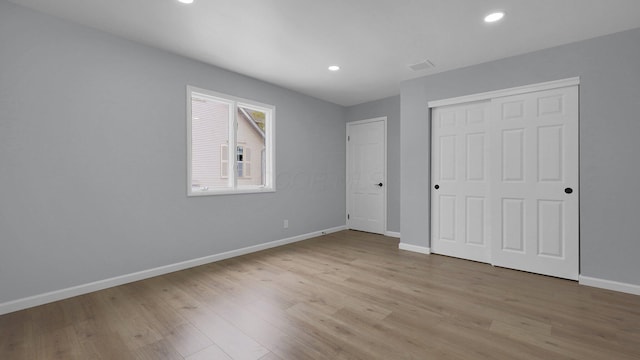 unfurnished bedroom featuring a closet and light hardwood / wood-style floors