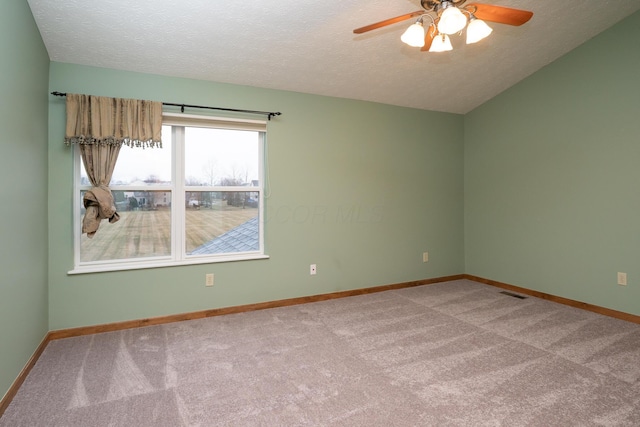 empty room featuring carpet floors, baseboards, visible vents, and a textured ceiling