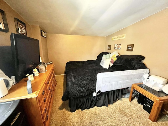 bedroom featuring carpet and vaulted ceiling