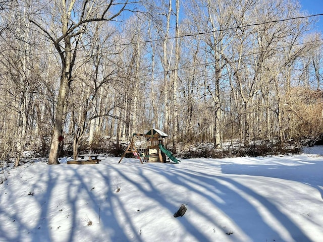 snowy yard with a playground