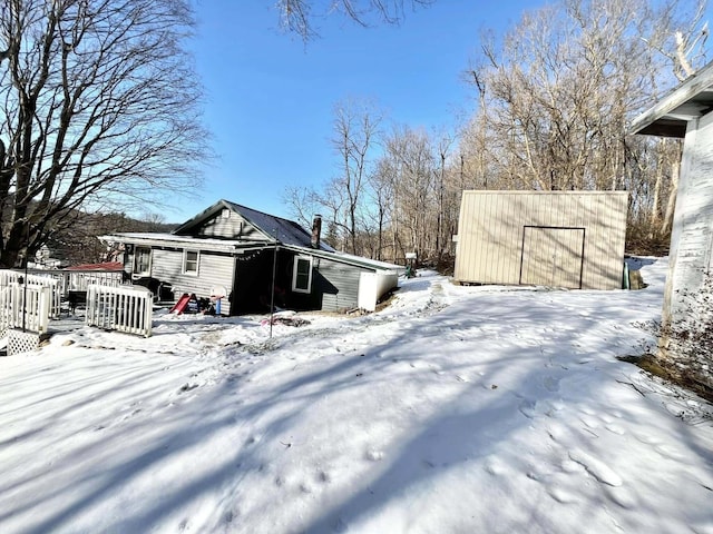 snowy yard with an outbuilding