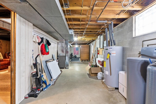 basement featuring heating unit and water heater