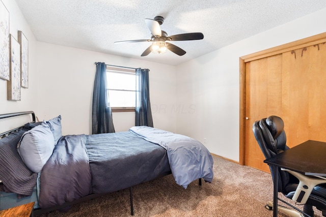 bedroom featuring a textured ceiling, a closet, ceiling fan, and carpet flooring