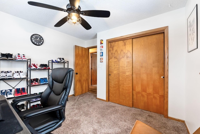 office with light carpet, ceiling fan, and a textured ceiling