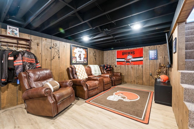 cinema room with wood-type flooring and wood walls