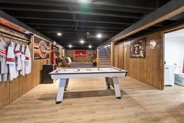 playroom featuring light hardwood / wood-style flooring and wood walls