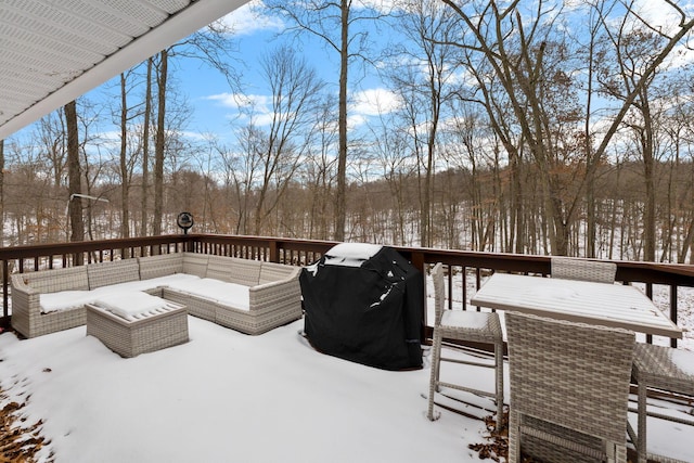 snow covered deck with an outdoor living space and a grill