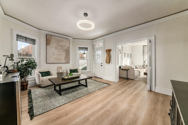 living room featuring crown molding and light hardwood / wood-style floors