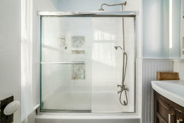 bathroom featuring vanity and shower / bath combination with glass door