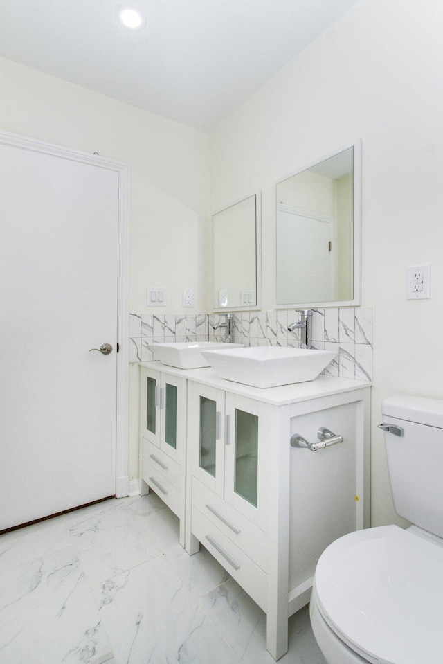 bathroom featuring toilet and vanity