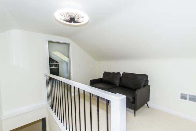 sitting room featuring light carpet and lofted ceiling