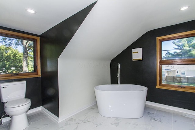 bathroom featuring a tub and toilet