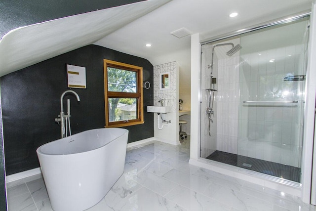 bathroom featuring lofted ceiling and separate shower and tub