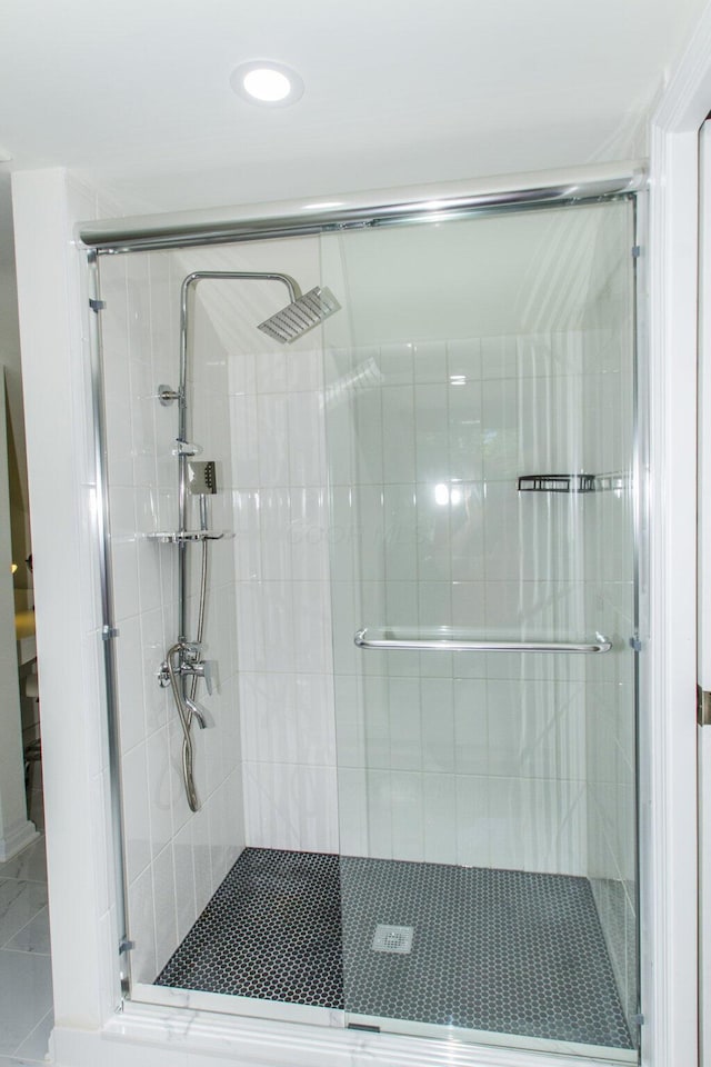 bathroom with a shower with shower door