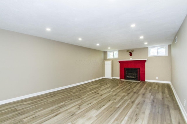 unfurnished living room with light hardwood / wood-style flooring and plenty of natural light