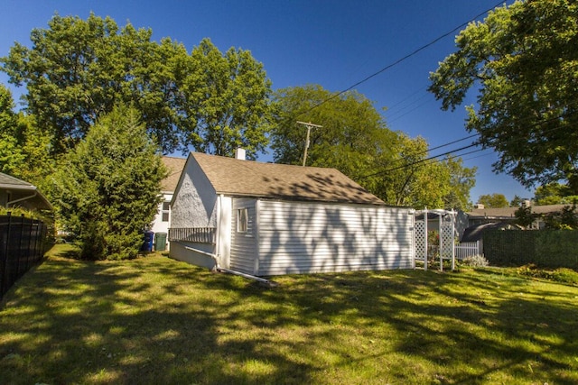 view of side of home with a yard