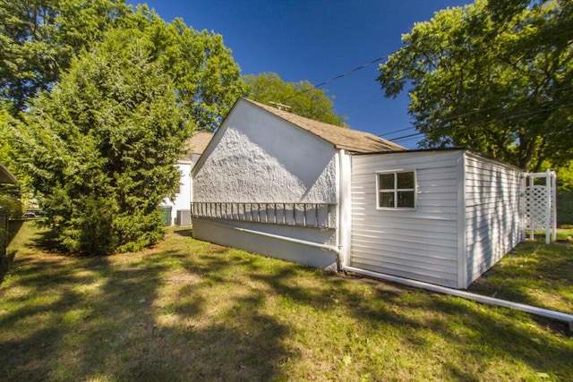 view of side of property with a yard