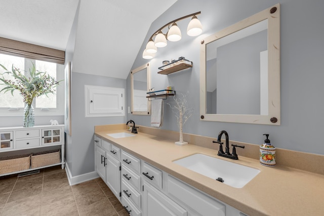 bathroom with lofted ceiling and vanity