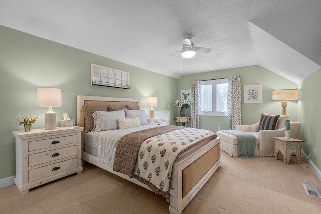 bedroom with light carpet, vaulted ceiling, and ceiling fan