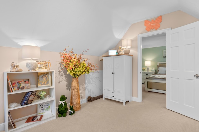 bedroom with light carpet and vaulted ceiling