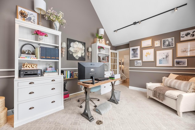 office featuring vaulted ceiling and track lighting