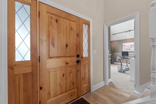 foyer entrance with light wood-type flooring