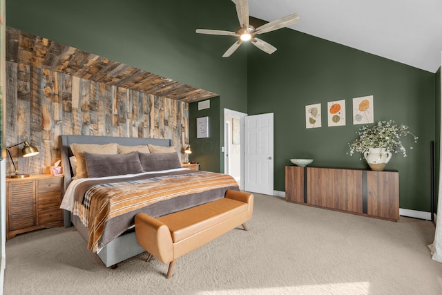 carpeted bedroom with ceiling fan and high vaulted ceiling