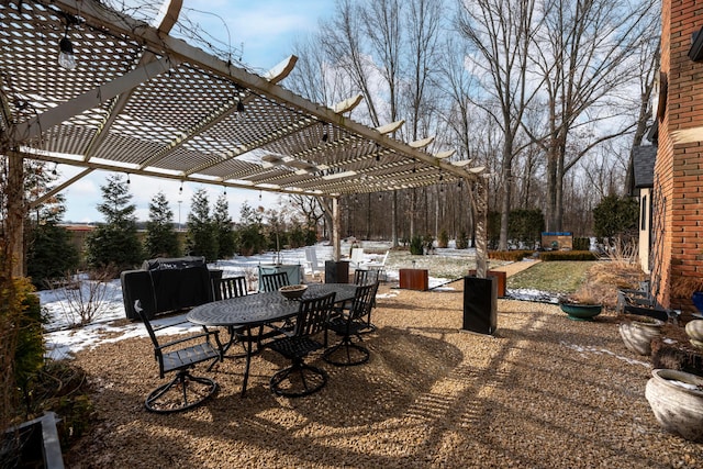 snow covered patio with a pergola