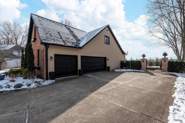 view of snow covered exterior with a garage