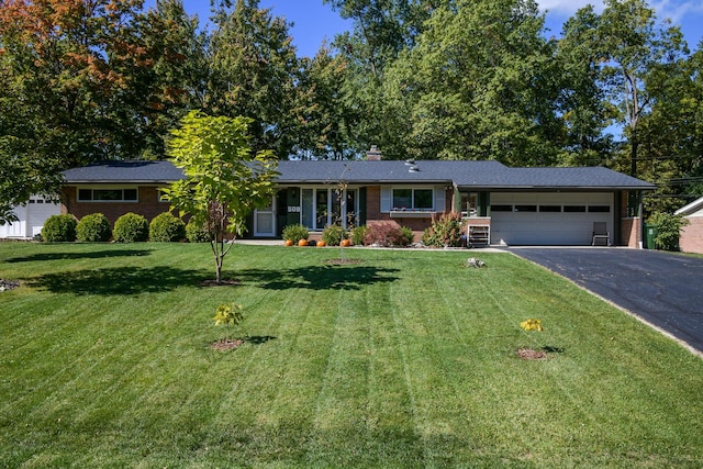 single story home with a front yard and a garage