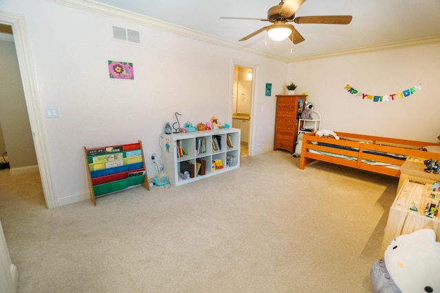 bedroom featuring ceiling fan, crown molding, ensuite bathroom, and carpet flooring