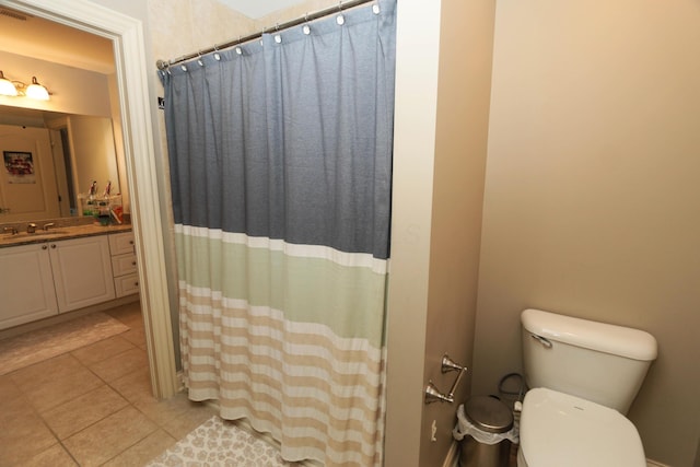 bathroom with toilet, vanity, a shower with curtain, and tile patterned flooring