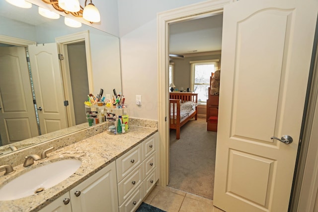 bathroom with vanity, a notable chandelier, and tile patterned flooring