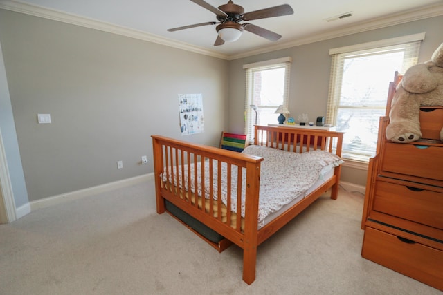 carpeted bedroom featuring ceiling fan and ornamental molding