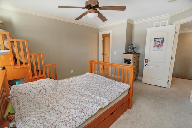 carpeted bedroom with ceiling fan and ornamental molding