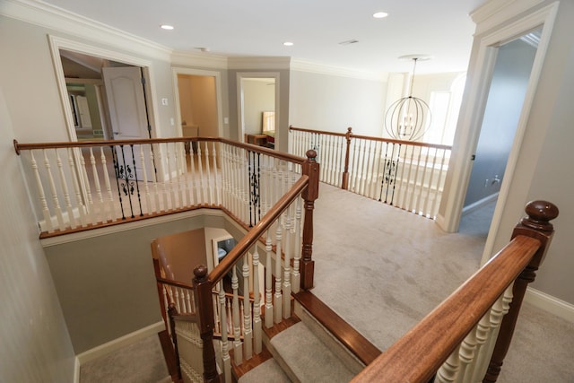 stairway with carpet, a notable chandelier, and crown molding