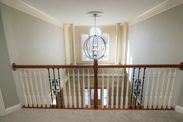 stairs featuring carpet floors, ornamental molding, and a chandelier